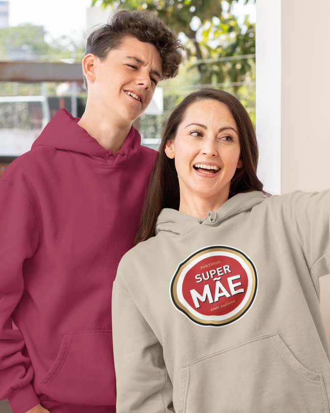 Two people taking a selfie, one wearing a maroon hoodie and the other wearing a gray hoodie with a 'Super Mae' logo.